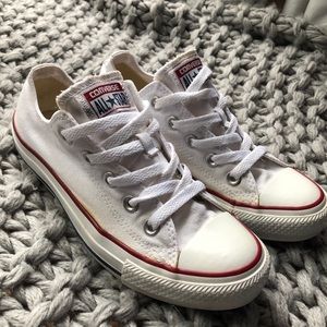 White low top Converse with red and blue stripe